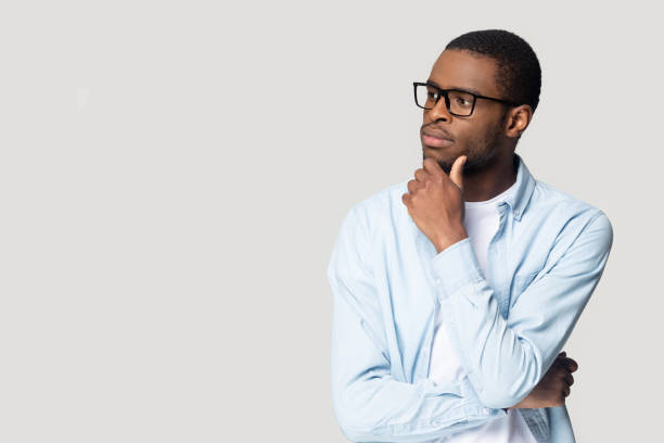 istock African concerned guy touch chin feels doubting studio shot 1227633014
