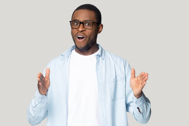 istock African guy stretched hands showing something long studio shot 1227633023