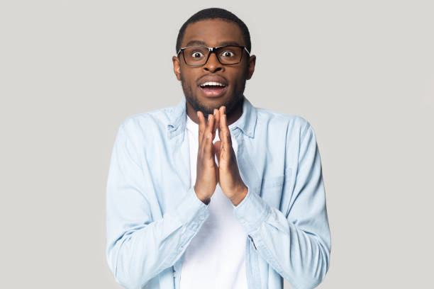 istock African guy expecting a miracle isolated on gray background 1227633032