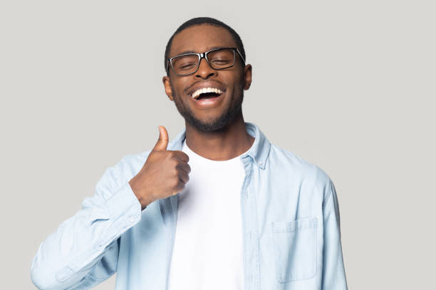 istock African guy showing thumbs up looking at camera studio shot 1227633035