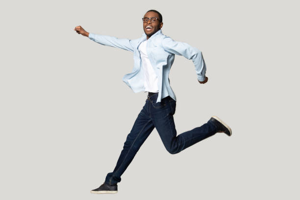 istock African guy posing in jump isolated on grey studio background 1227633040