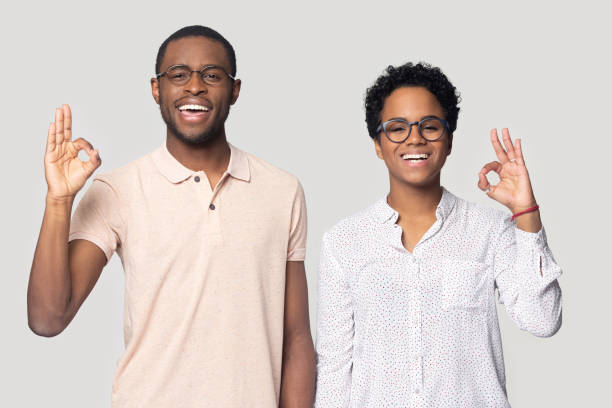 istock Happy african couple look at camera showing ok hand gesture 1227633068
