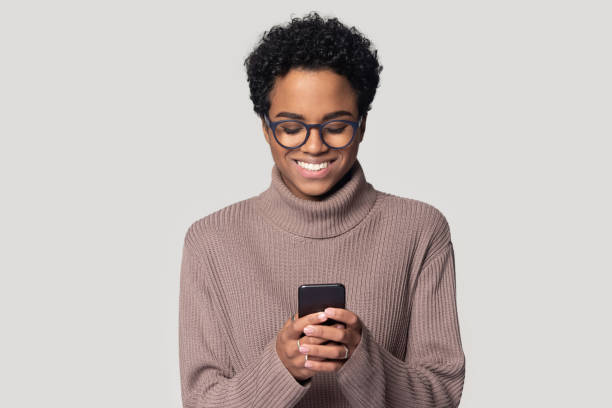 istock African woman holding smartphone makes order online studio shot 1227633129
