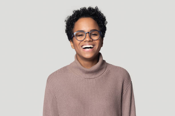 istock African young woman laughing posing on gray studio background 1227633131