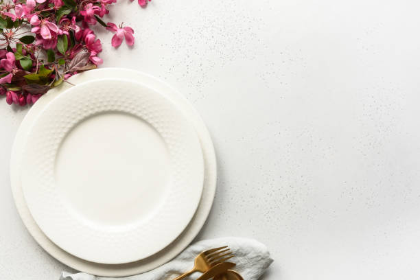 istock Elegance table setting with apple tree flowers, golden cutlery on white. Space for text. Top view. 1227633434