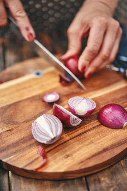 istock Cutting Onions on Wooden Cutting Board 1227634644