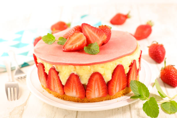 istock strawberry cake with cream on wood background 1227636128