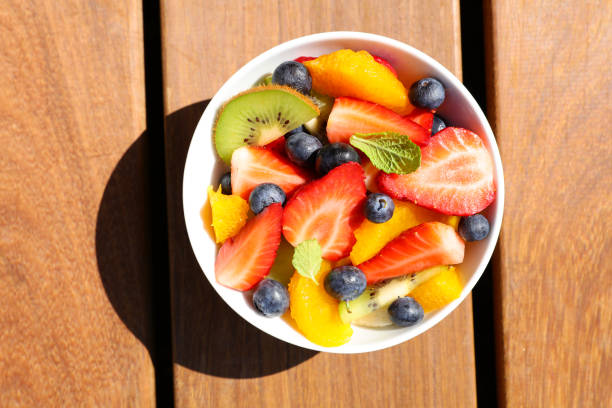 istock fresh fruit salad in bowl- top view 1227636139