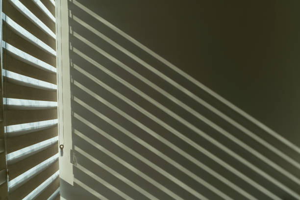 Abstract shadow and lights on white wall from window, monochrome, black and white Abstract shadow on the wall