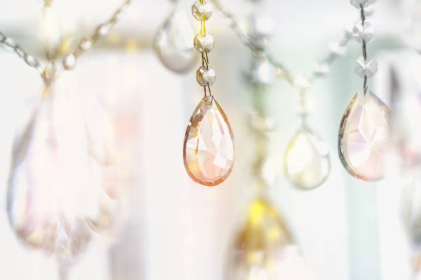Beautiful multicolored light reflecting through brushed  glass crystals hanging on vintage chandelier