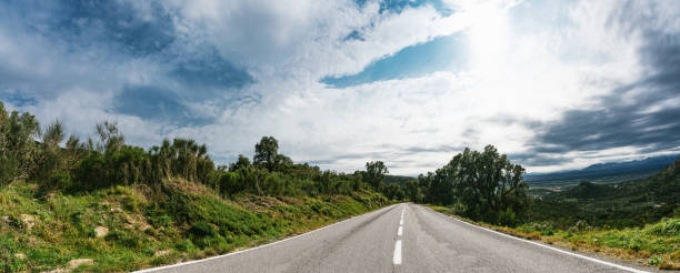 istock Empty long road on a sunny summer day at bright sunset 1227644393