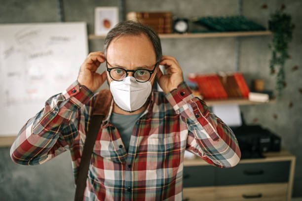 istock Businessman wearing face mask while leaving after work 1227645252