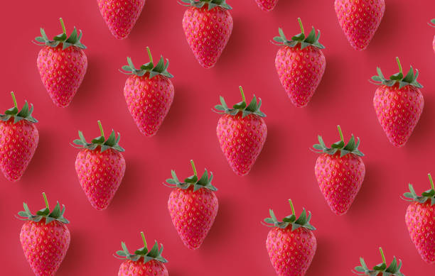 istock Colourful  seamless pattern made of red strawberries on red background 1227645676