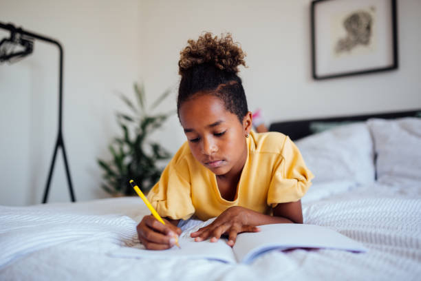 istock Little African American girl doing homework 1227645688