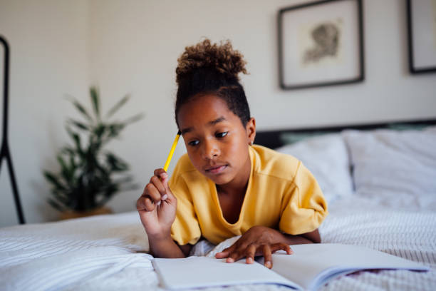 istock Little African American girl doing homework 1227645695