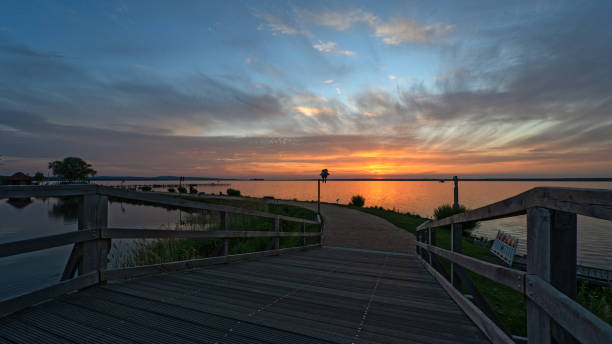 istock Bridge and promenade with majestic cloudscape at sunset 1227646300