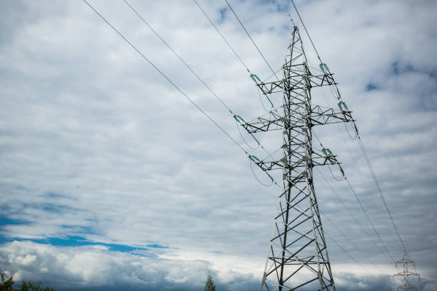 istock Transmission tower with high voltage wires. Blue sky with clouds on the background. 1227646346