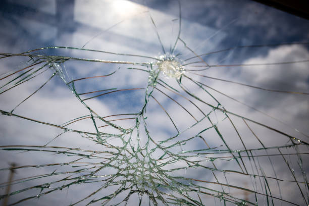 istock Broken Glass with Blue Sky and Clouds in Background. 1227646348