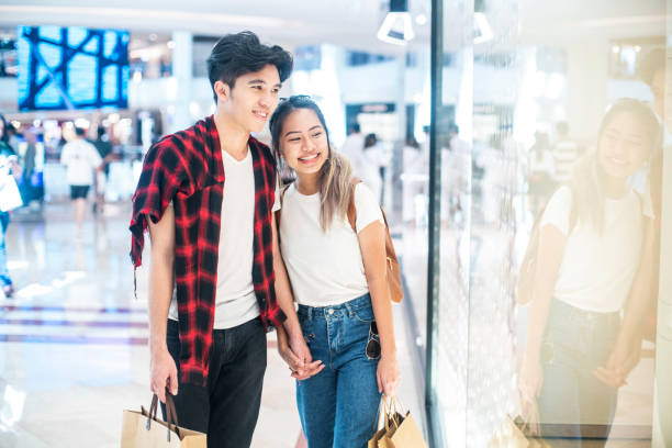 istock Young couple window shopping in the mall 1227646357