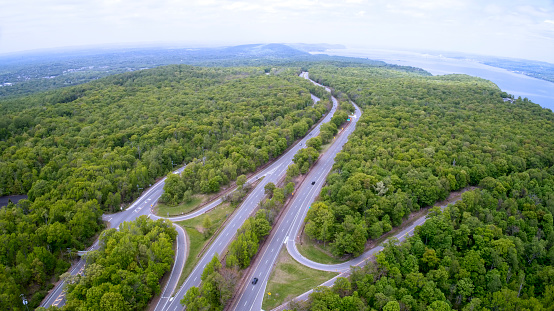 Highways, Forest and Hudson River from above looking north into New York State at New Jersey border. Mario Cuomo Bridge in distance.