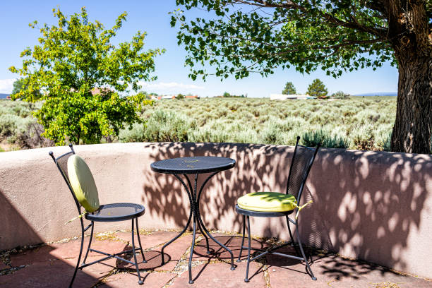 backyard patio terrace garden with chairs and table in ranchos de taos valley and green landscape in summer sunny day and nobody - ranchos de taos imagens e fotografias de stock