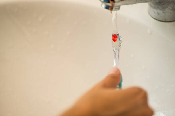 istock running water on toothbrush personal hygiene 1227651800