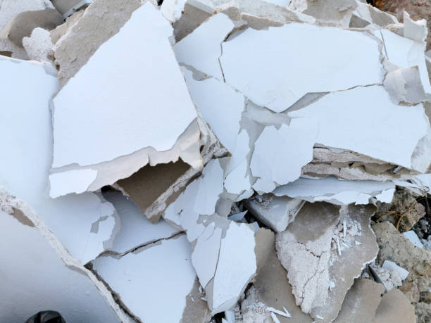 istock Demolished white brocken plasterboard wall, construction and repair 1227652456