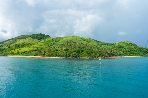 Photo of a green tropical island in a turquoise sea
