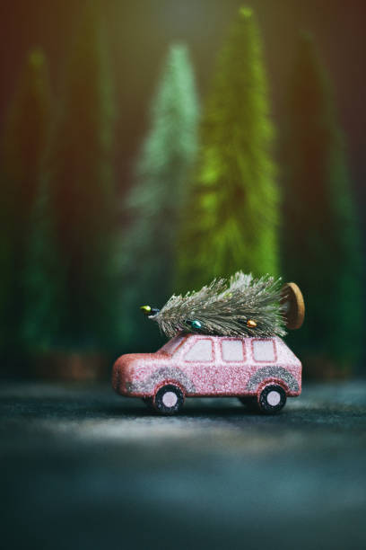istock Pink car transporting Christmas tree. Christmas holiday background. 1227653330