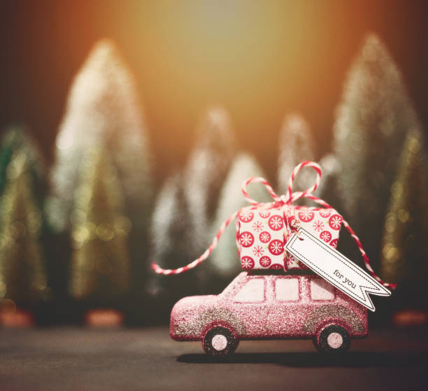 istock Pink car transporting Christmas gift. Christmas holiday background. 1227653338