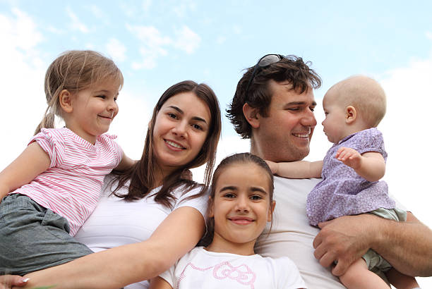 Happy family portrait smiling - isolated over a white background