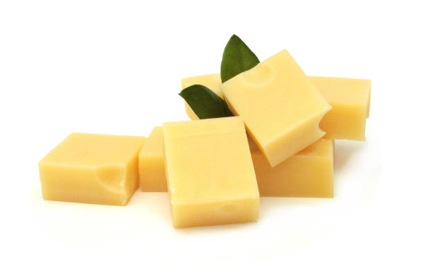 istock Cubes of cheddar cheese isolated on white 1227662925