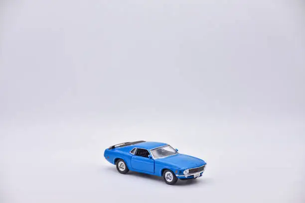 blue toy car on white background, blue car closeup