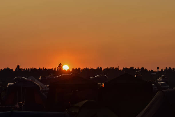 istock sunset over campground, orange sunset, orange sky 1227727950