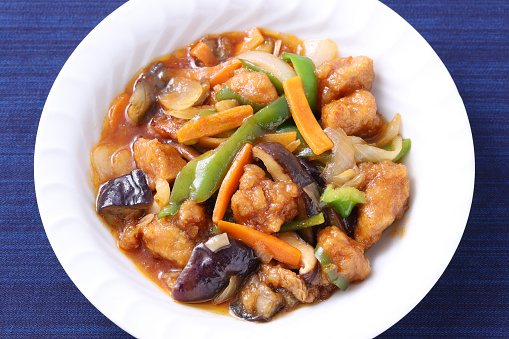 Chinese food fried cooked pork and vegetables seasoned with vinegar, sweet and sour pork