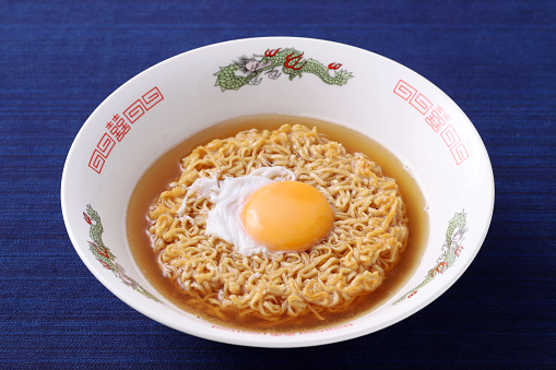 Japanese instant chicken noodles in a bowl on white background
