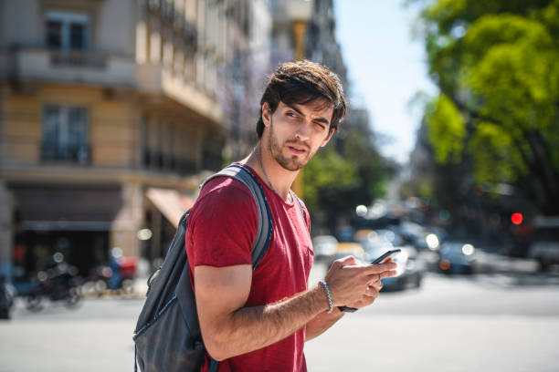 istock Young Male Vacationer Checking Directions on Smart Phone 1227810762