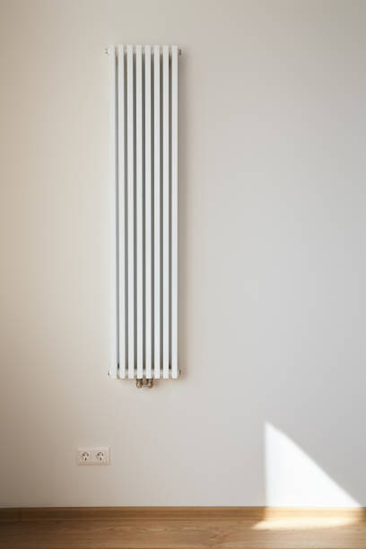 istock white and modern heating radiator near wall with power sockets 1227854210