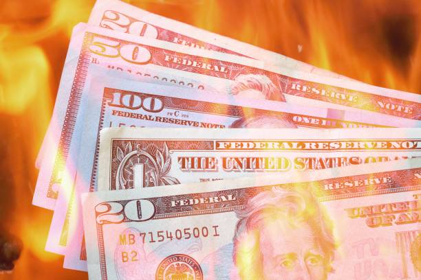 istock USA currency on fire, burning through cash concept 1227867535