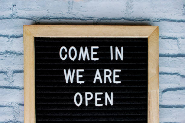 istock Come in we are open, message on a blackboard 1227869576