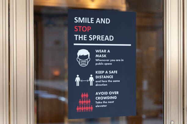 Poster explaining COVID-19 rules is displayed in a window in Lower Manhattan.