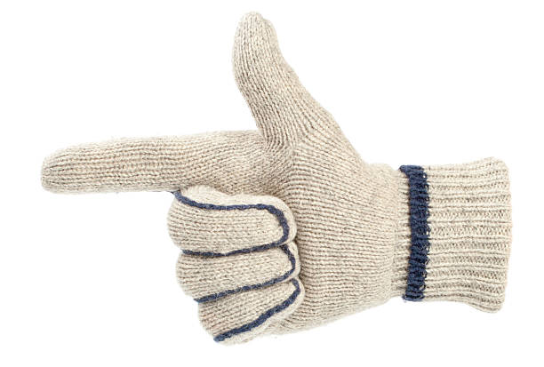 Doctor hands in rubber protective gloves showing heart shape on yellow background