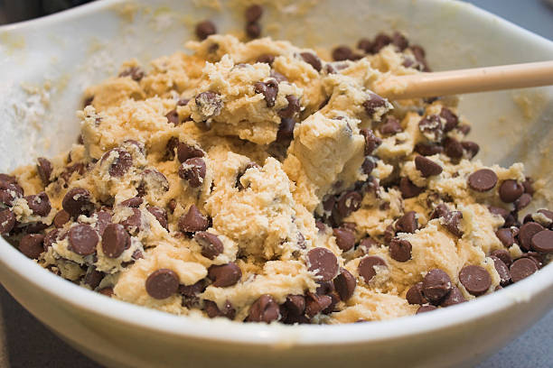 Homemade chocolate chip cookies dough scoops on a baking sheet.