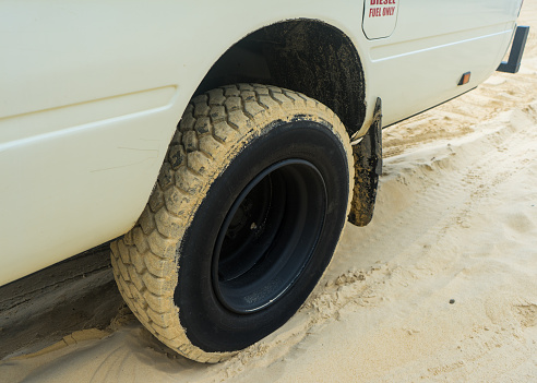 Four wheel drive 4WD bus tyre driving through sand