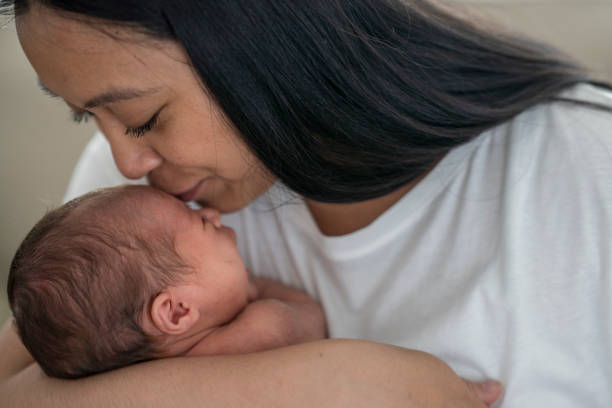 istock New mother holding her daughter closely and showing affection 1228577824