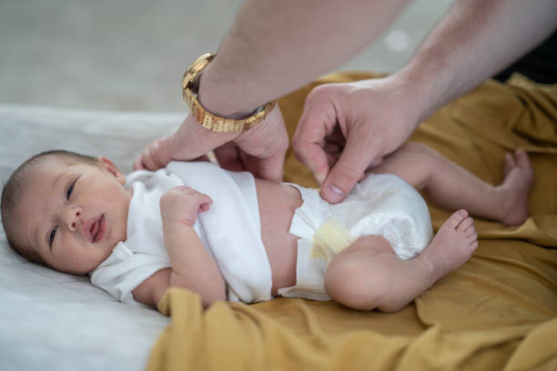 istock New dad putting a diaper on his one week old daughter 1228577918