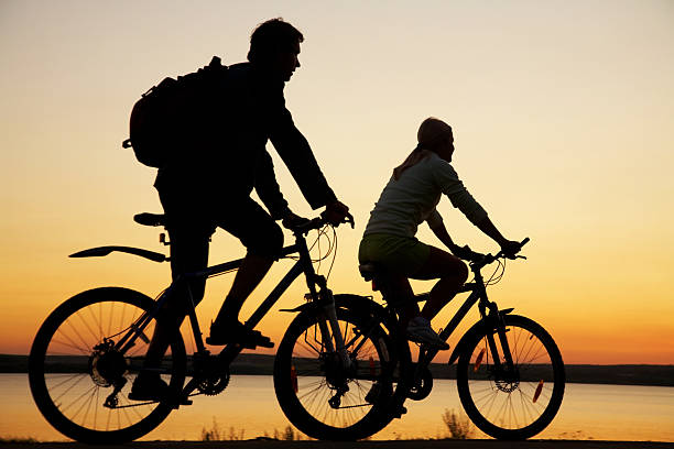 istock Young couple riding bicycles at sunset. 122860495