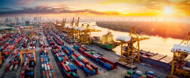 istock Logistics and transportation of Container Cargo ship and Cargo plane with working crane bridge in shipyard at sunrise, logistic import export and transport industry background 1228777319