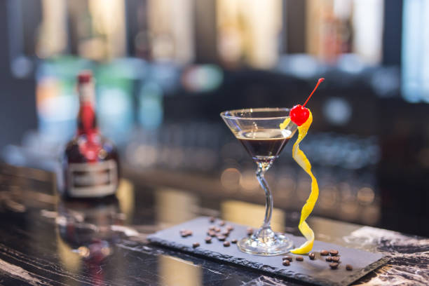 istock cocktail with orange peel and red cherry on a martini glass 1228798917