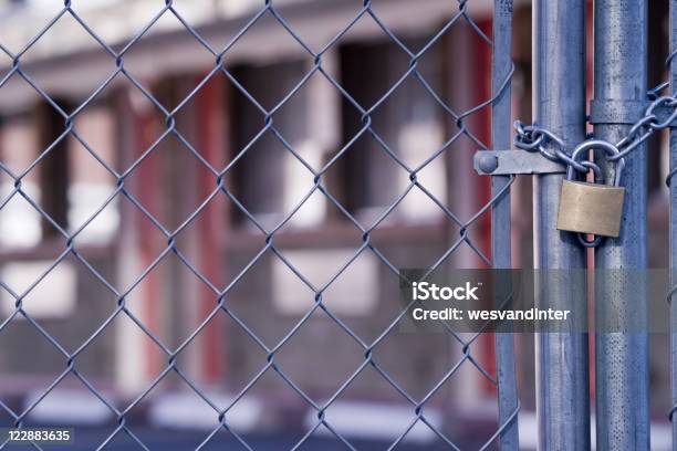 Abandoned Hotel And Chain Link Fence Stock Photo - Download Image Now - Abandoned, Blue, Chainlink Fence